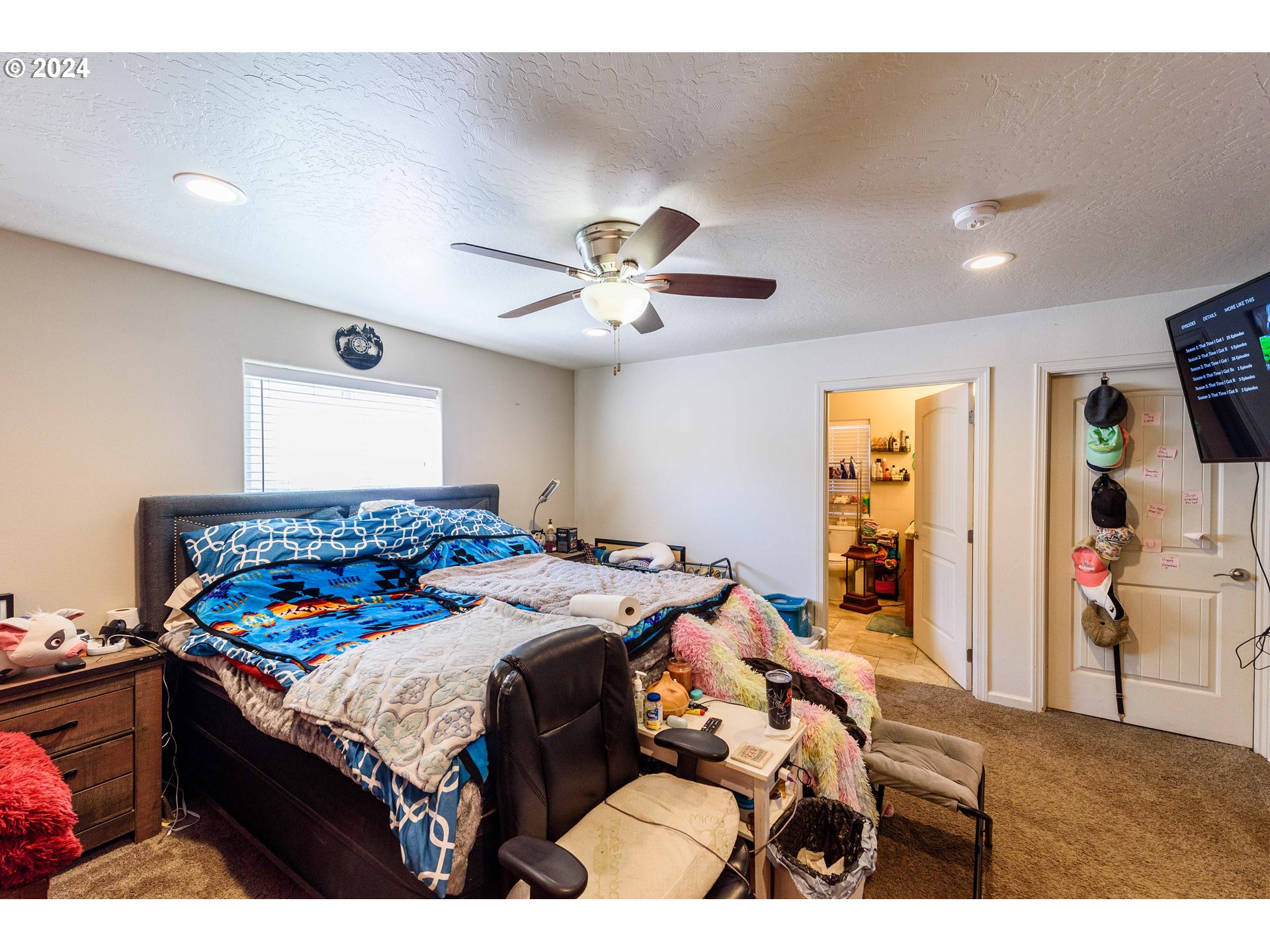 63464 James Drive Coos Bay, OR 97420 - Photo 11 of 25 a bedroom with a bed and a chandelier