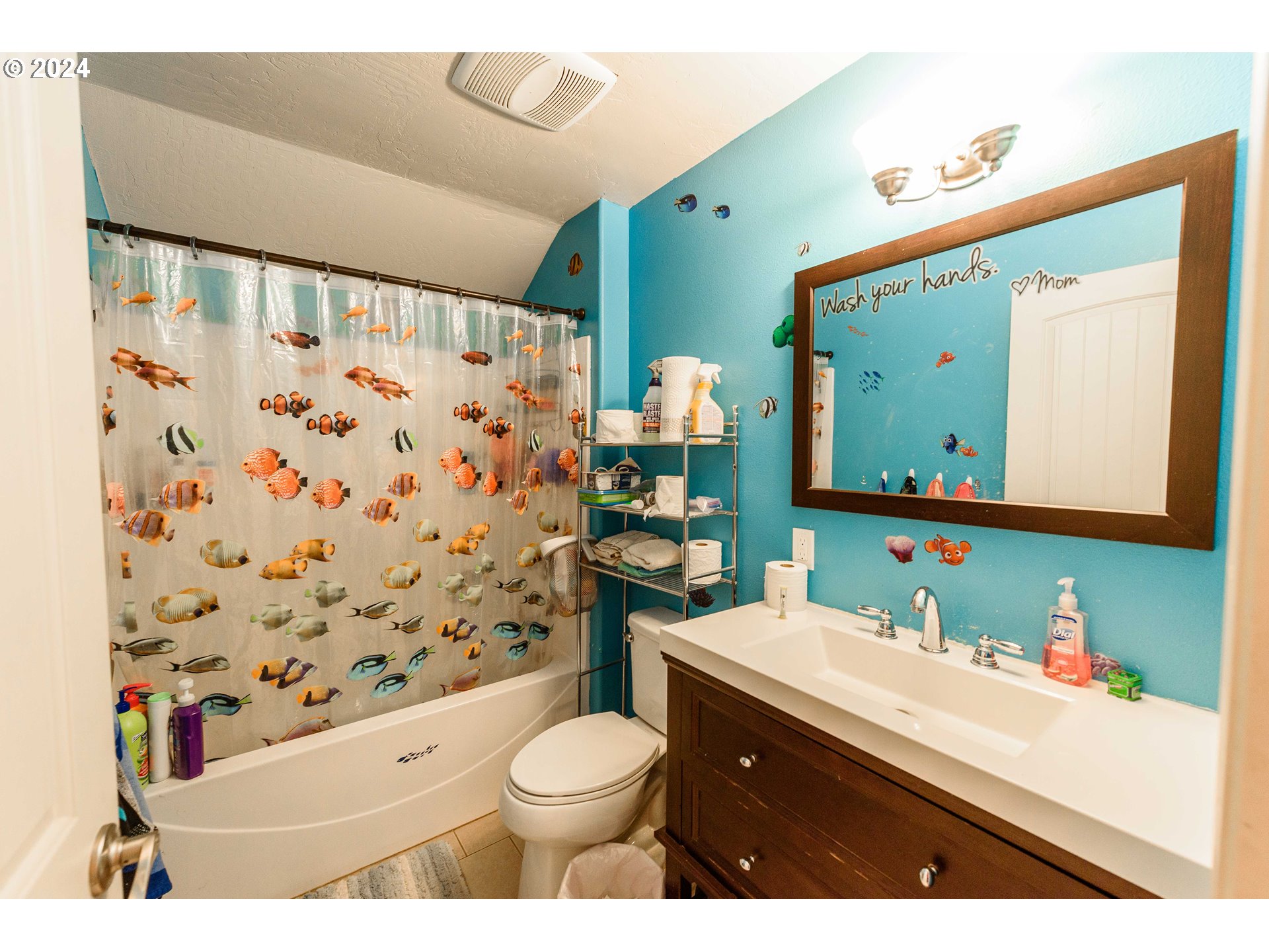 63464 James Drive Coos Bay, OR 97420 - Photo 15 of 25 a bathroom with a sink a toilet and shower curtain
