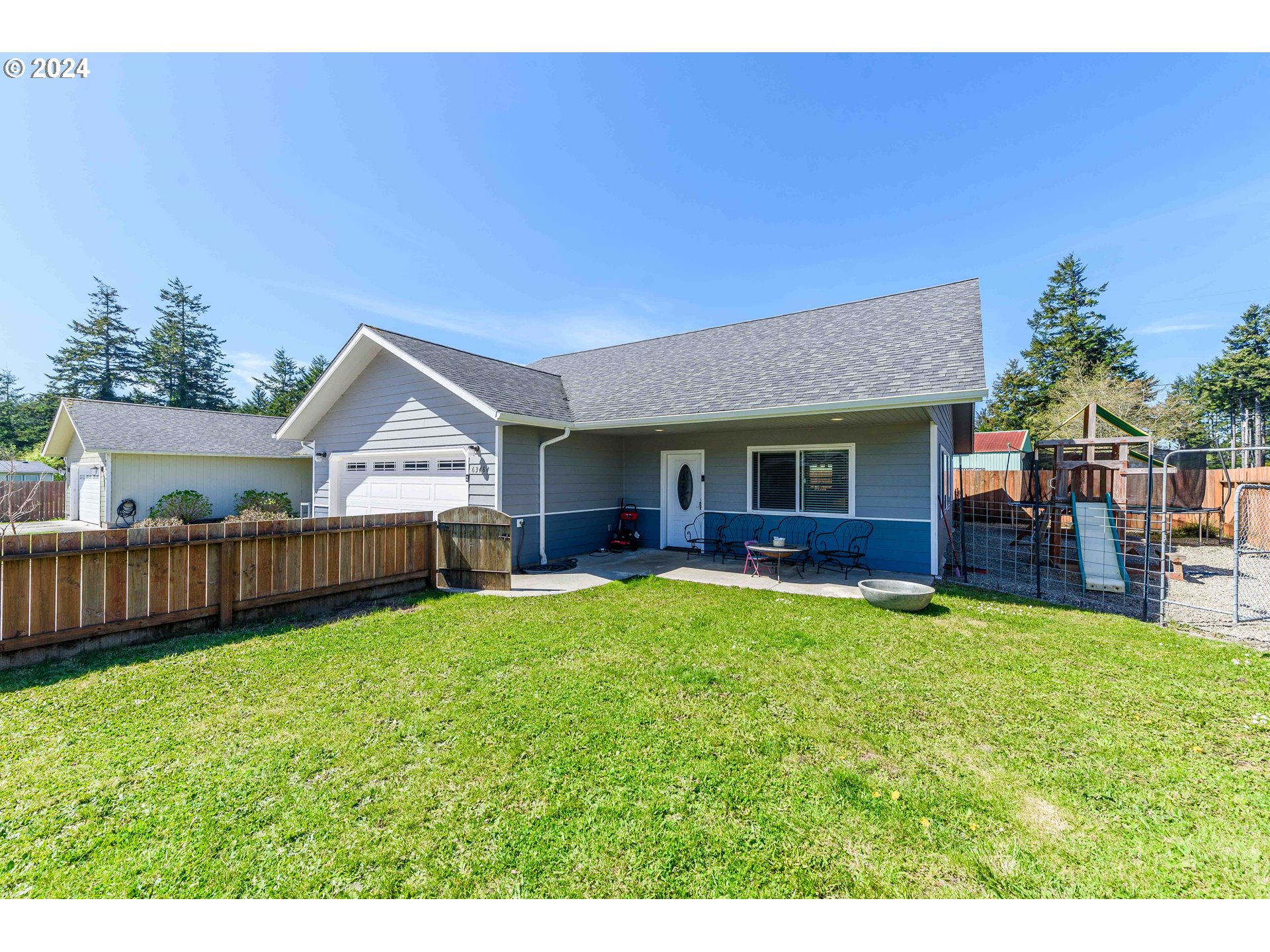 63464 James Drive Coos Bay, OR 97420 - Photo 2 of 25 a view of a house with a yard and deck