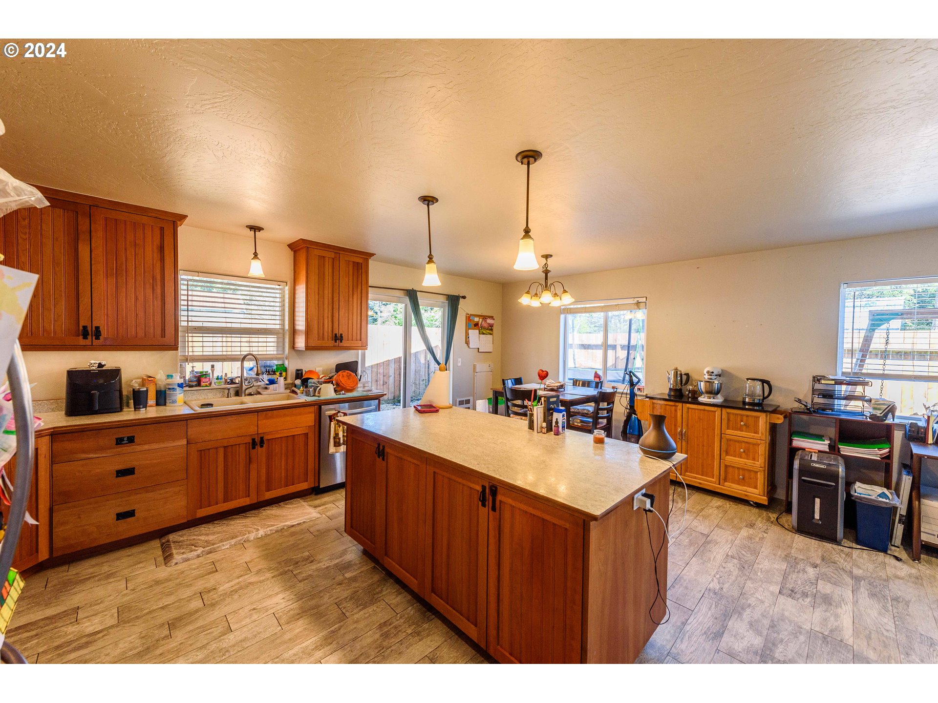 63464 James Drive Coos Bay, OR 97420 - Photo 5 of 25 a kitchen with sink a stove and chairs