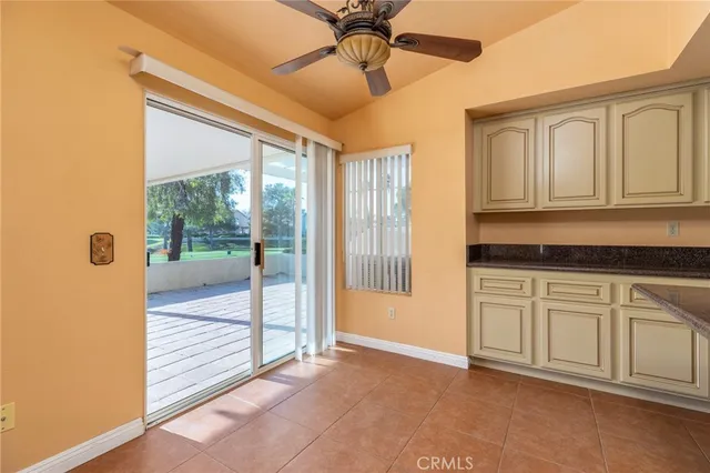 a view of a kitchen with cabinet and a ceiling fan