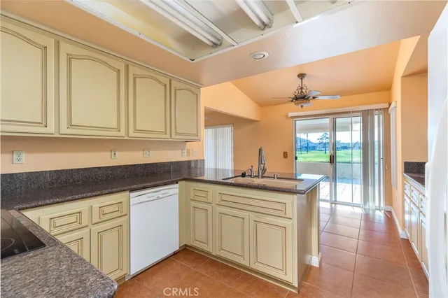 a kitchen with granite countertop a sink and cabinets