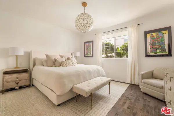 a bedroom with bed and a couch