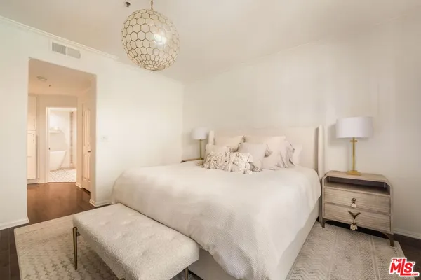 a bedroom with a bed and a lamp