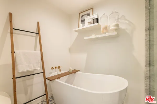 a white bath tub sitting next to a white sink