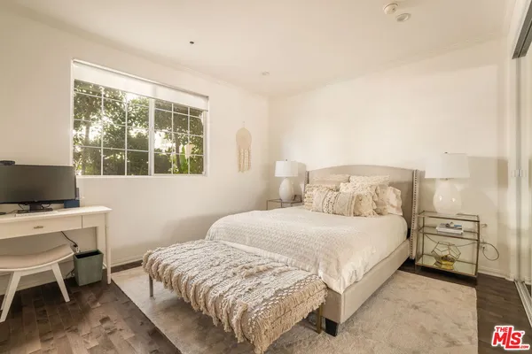 a bedroom with a bed and a desk