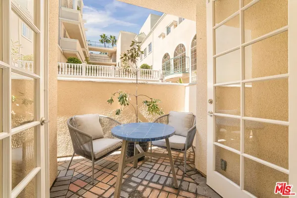 a view of a dining room with furniture a rug and wooden floor