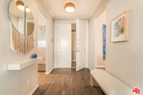 a view of a hallway with wooden floor and entryway
