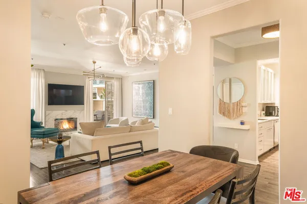 a living room with dining table furniture and a flat screen tv