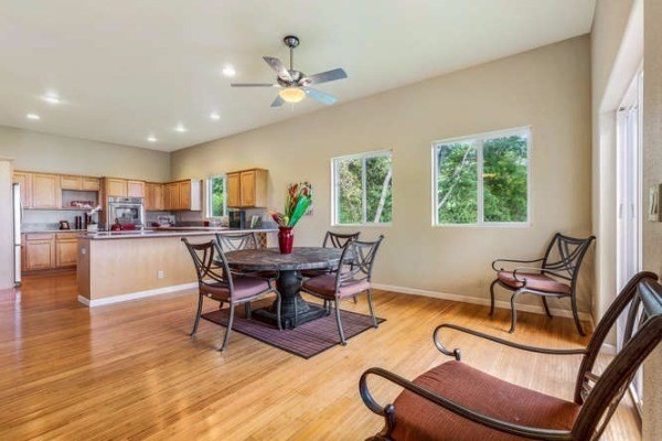87-410 Kaohe Mauka Road Captain Cook, HI 96704 - Photo 11 of 29 a view of a dining room with furniture window and wooden floor