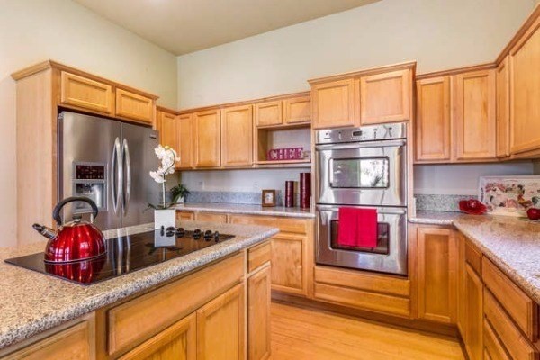 87-410 Kaohe Mauka Road Captain Cook, HI 96704 - Photo 13 of 29 a kitchen with stainless steel appliances granite countertop a sink refrigerator and cabinets