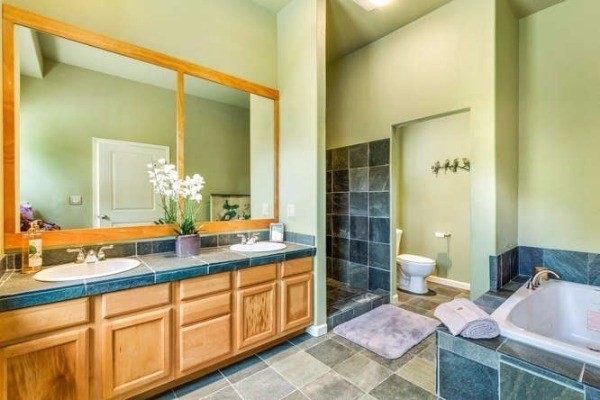 87-410 Kaohe Mauka Road Captain Cook, HI 96704 - Photo 19 of 29 a spacious bathroom with a granite countertop sink and a mirror