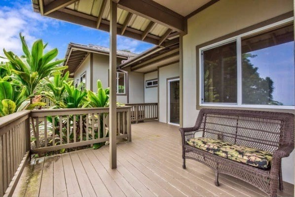 87-410 Kaohe Mauka Road Captain Cook, HI 96704 - Photo 25 of 29 a view of a balcony with chairs and wooden floor