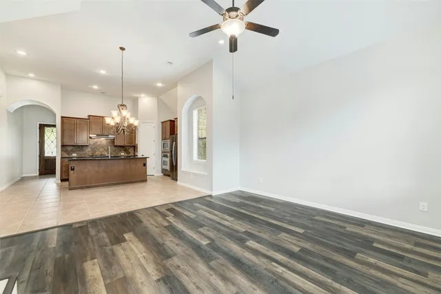a view of a kitchen with kitchen island a sink stainless steel appliances and cabinets