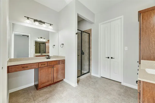 a spacious bathroom with a double vanity sink and a mirror