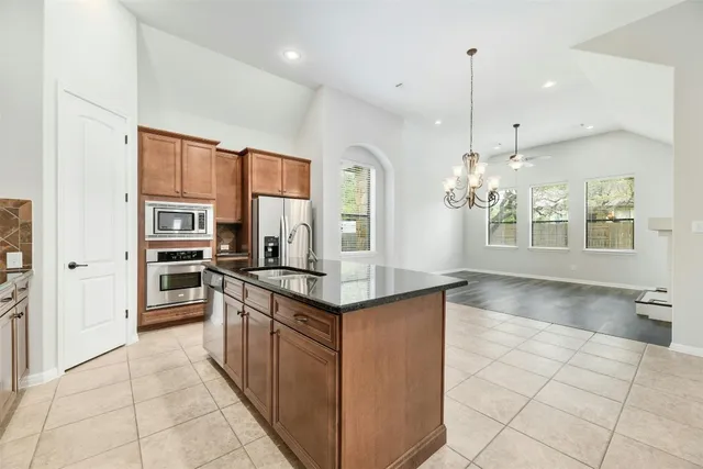 a kitchen with stainless steel appliances granite countertop a stove and a sink