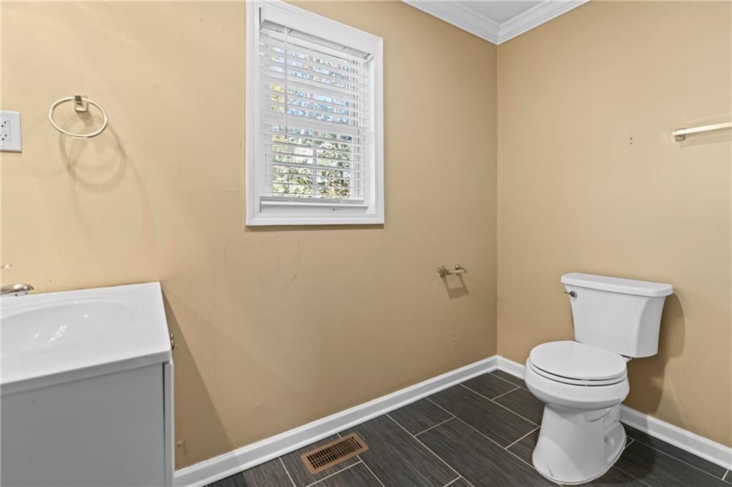 159 Walnut Street Northwest Atlanta, GA 30314 - Photo 15 of 19 a white toilet sitting next to a bathroom sink