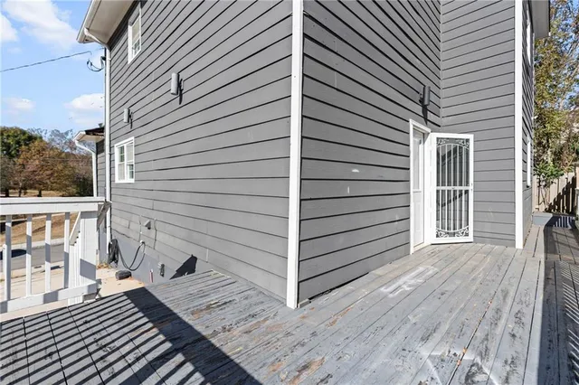 a view of a balcony with wooden floor and fence