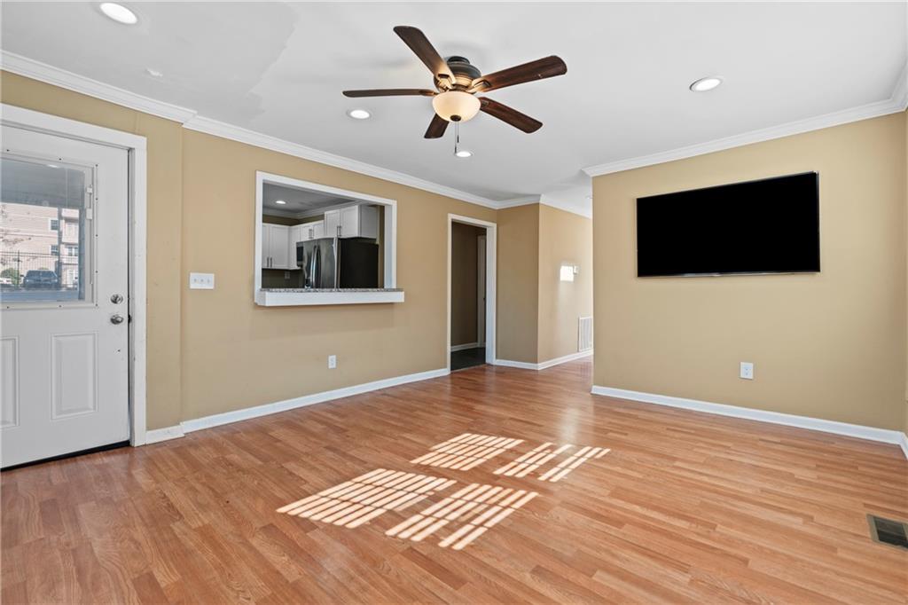 159 Walnut Street Northwest Atlanta, GA 30314 - Photo 3 of 19 a living room with a flat screen tv and a ceiling fan