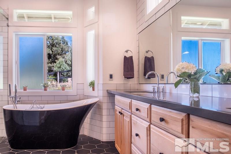 2071 Empire Road Reno, NV 89521 - Photo 11 of 25 a room with granite countertop a sink and a mirror