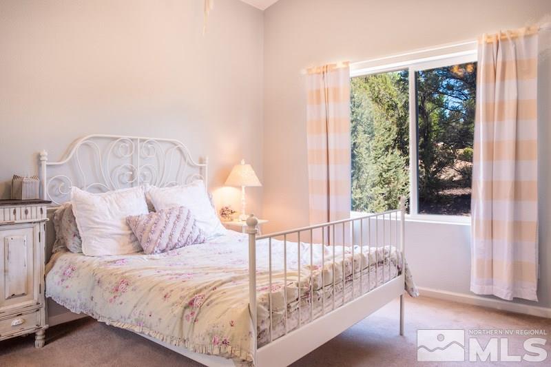 2071 Empire Road Reno, NV 89521 - Photo 15 of 25 a bed sitting in a bedroom next to a window