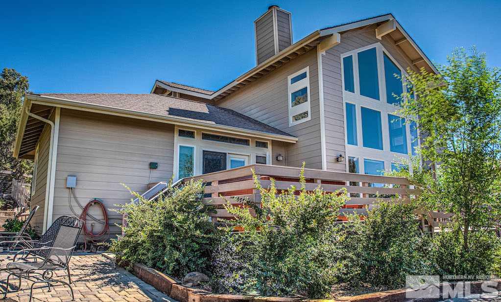 2071 Empire Road Reno, NV 89521 - Photo 20 of 25 a front view of house with yard and trees in the background