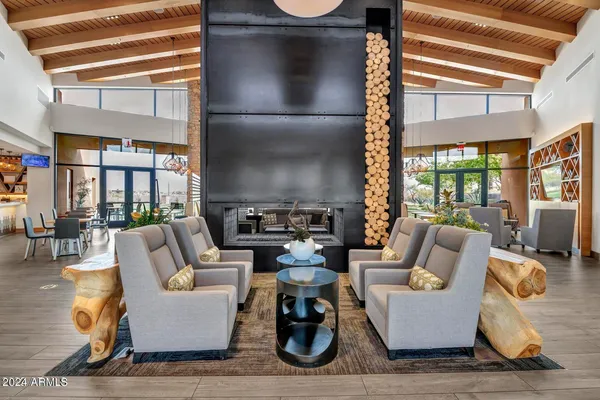 a living room with furniture and floor to ceiling windows