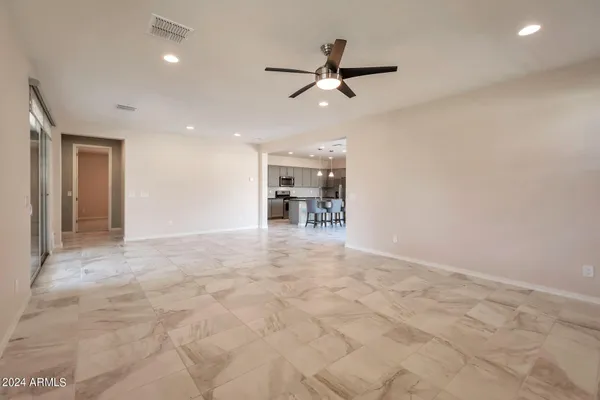 a view of a livingroom with a ceiling fan and window