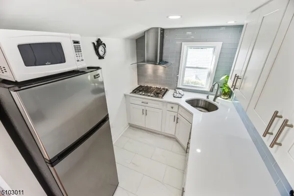 a kitchen with a microwave a stove and a refrigerator