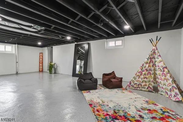 a hallway with a couch and a chandelier