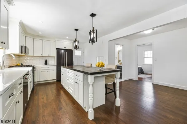 a kitchen with sink cabinets and wooden floor