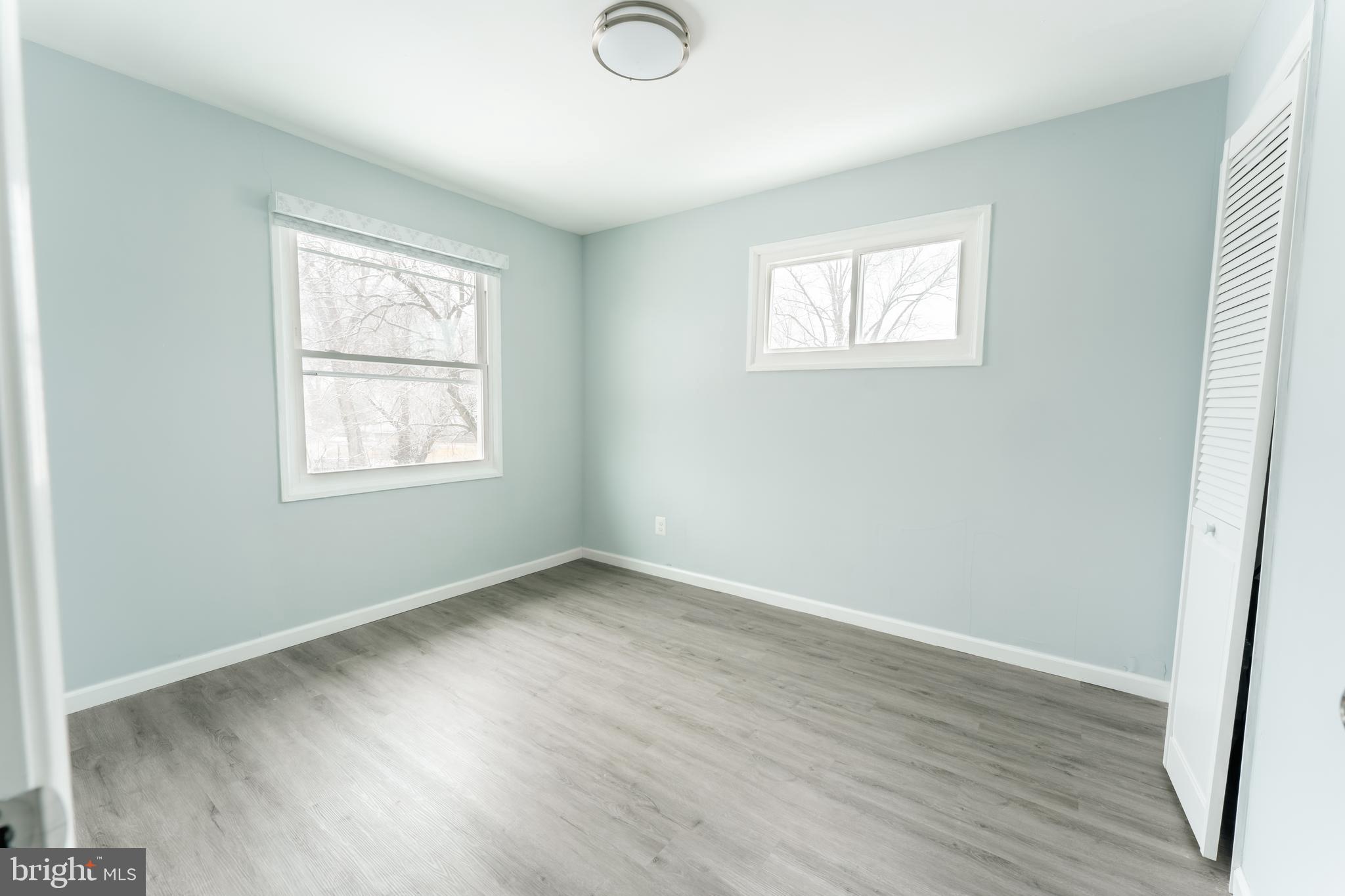 3410 Embry Street Silver Spring, MD 20902 - Photo 10 of 28 a view of an empty room with wooden floor and a window