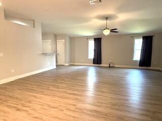 8544 Laredo Street Navarre, FL 32566 - Photo 13 of 36 an empty room with wooden floor and windows