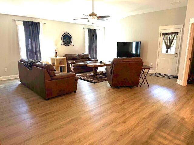 8544 Laredo Street Navarre, FL 32566 - Photo 14 of 36 a living room with furniture and a flat screen tv