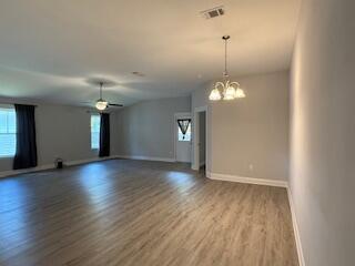 8544 Laredo Street Navarre, FL 32566 - Photo 15 of 36 a view of a room with wooden floor and chandelier
