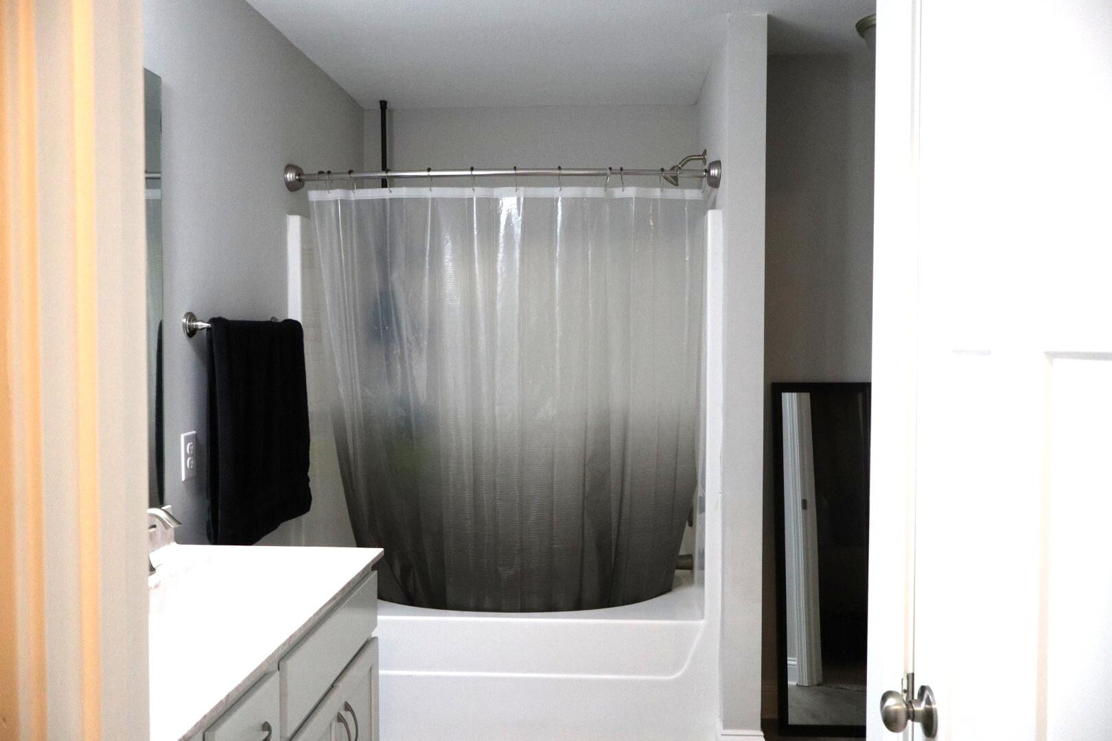 8544 Laredo Street Navarre, FL 32566 - Photo 21 of 36 a bathroom with a shower and a tub