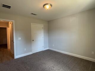 8544 Laredo Street Navarre, FL 32566 - Photo 26 of 36 en empty room with windows and entrance