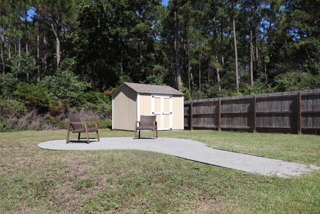 8544 Laredo Street Navarre, FL 32566 - Photo 31 of 36 a backyard of a house with table and chairs