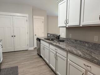 8544 Laredo Street Navarre, FL 32566 - Photo 6 of 36 a kitchen with granite countertop white cabinets and sink