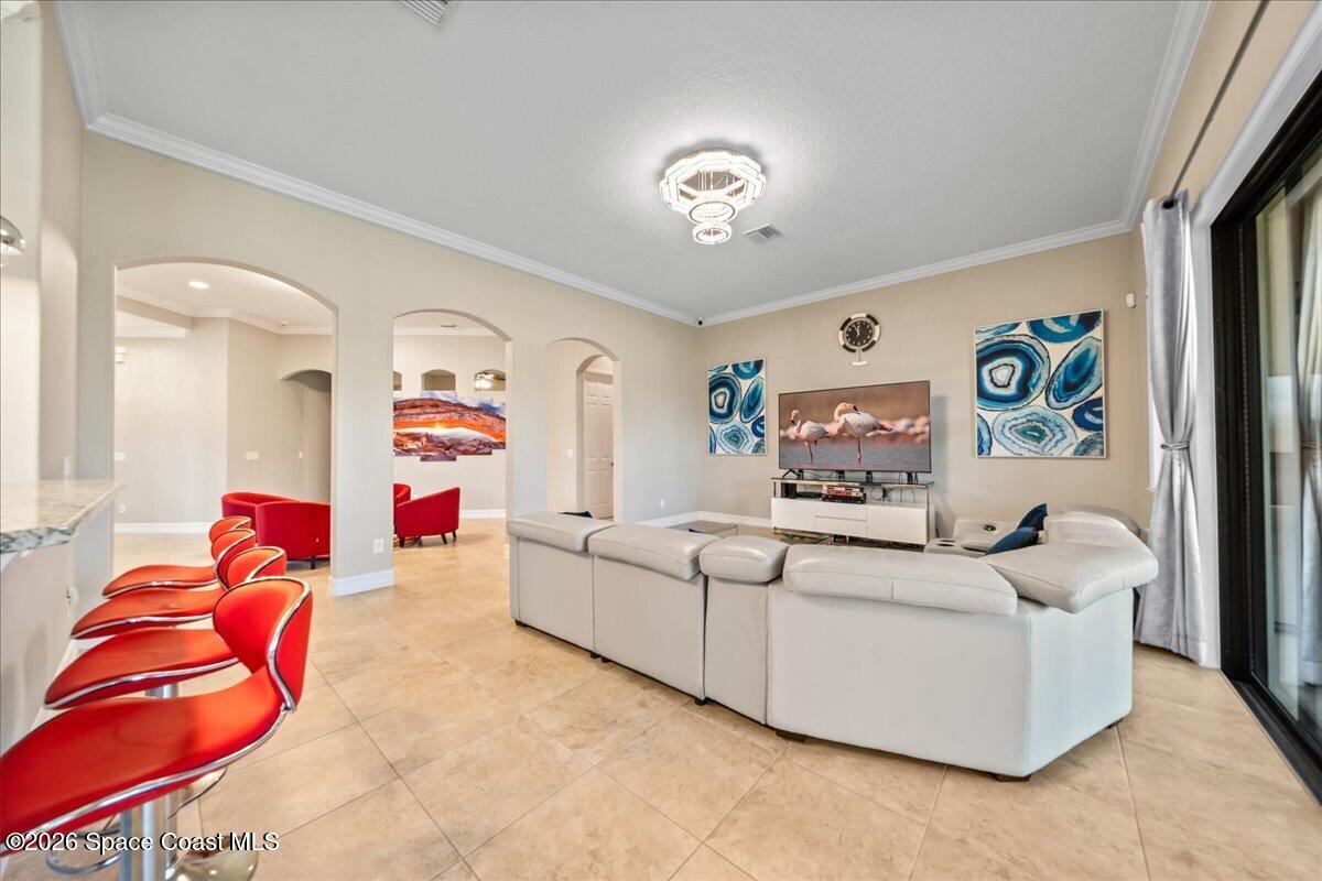 2906 Balting Place Melbourne, FL 32940 - Photo 14 of 44 a living room with furniture and a flat screen tv