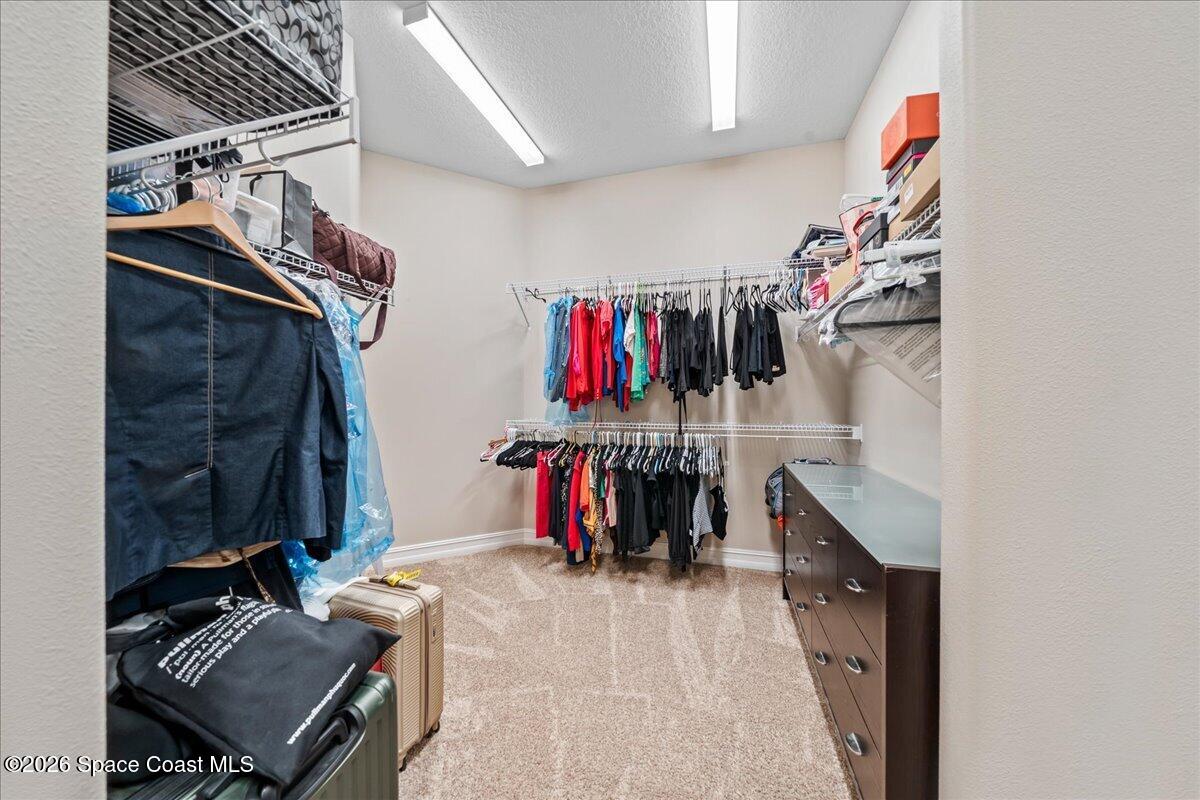 2906 Balting Place Melbourne, FL 32940 - Photo 27 of 44 a view of walk in closet with clothes