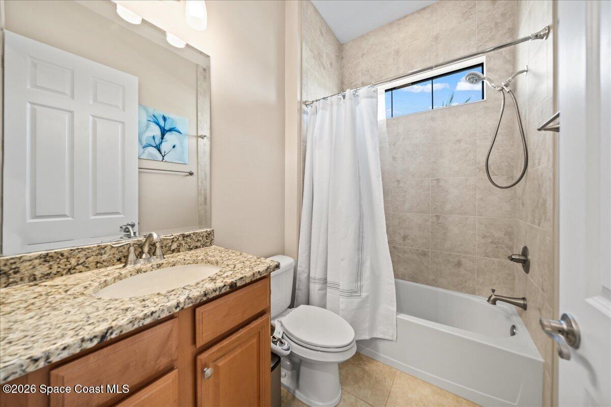 2906 Balting Place Melbourne, FL 32940 - Photo 30 of 44 a bathroom with a granite countertop sink toilet and shower