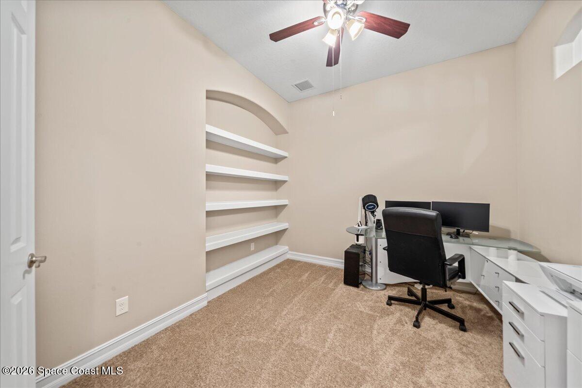 2906 Balting Place Melbourne, FL 32940 - Photo 33 of 44 a view of a workspace with furniture and a ceiling fan