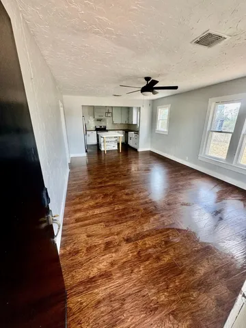 a view of entryway and hall with wooden floor