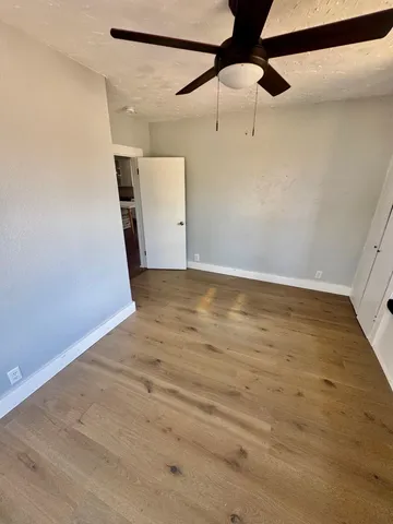 a view of a room with wooden floor