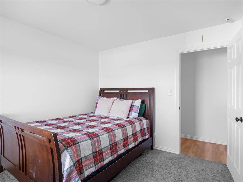 781 Alsdorf Road Ennis, TX 75119 - Photo 19 of 39 a bedroom with a bed and a night stand