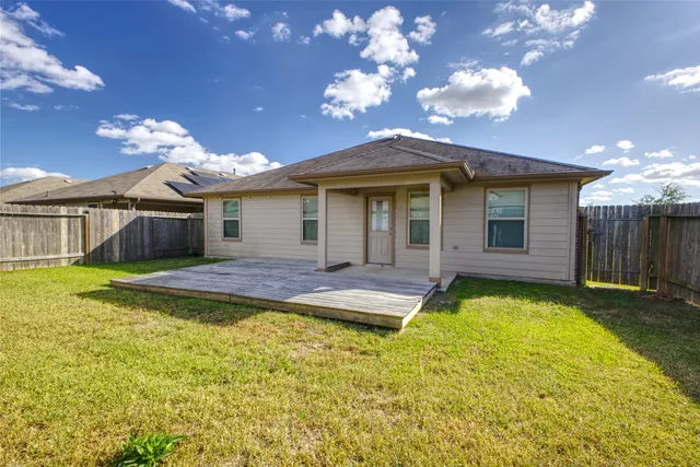 a view of a house with swimming pool and a yard