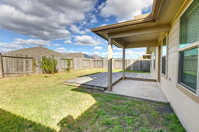 a view of an house with backyard and porch