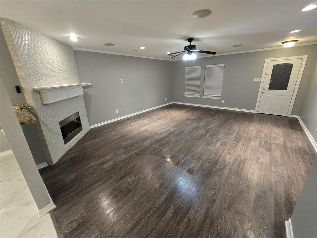 700 White Fields Way Arlington, TX 76002 - Photo 12 of 31 an empty room with wooden floor and fireplace