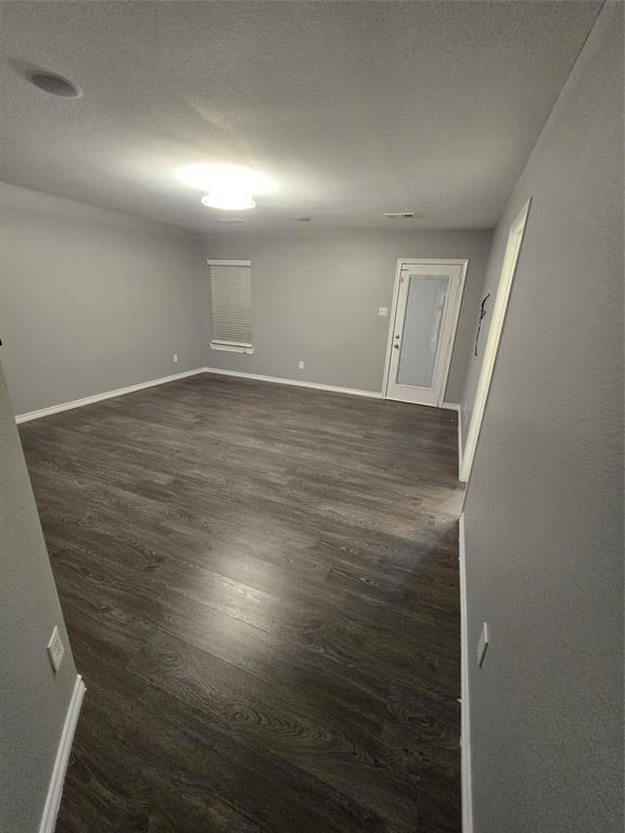 700 White Fields Way Arlington, TX 76002 - Photo 18 of 31 an empty room with wooden floor and windows